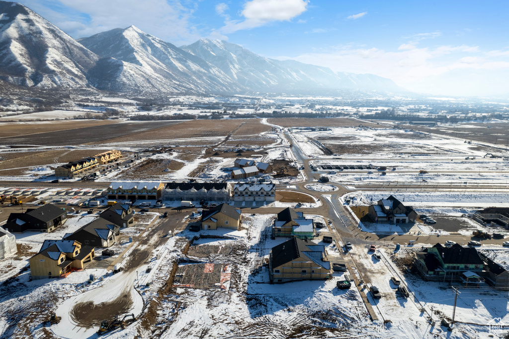 Snowy aerial view with a mountain view and a residential view