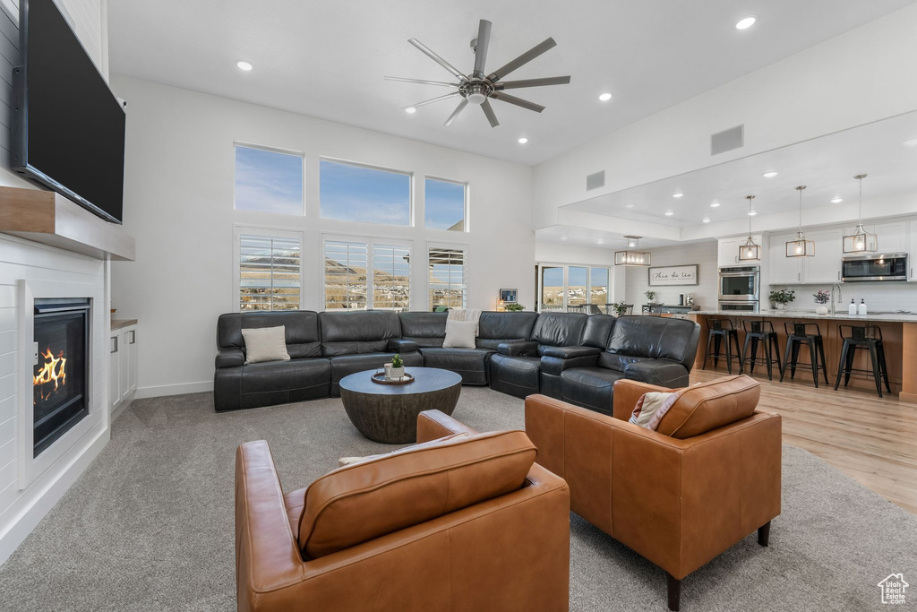 Living area featuring visible vents, recessed lighting, baseboards, and a glass covered fireplace