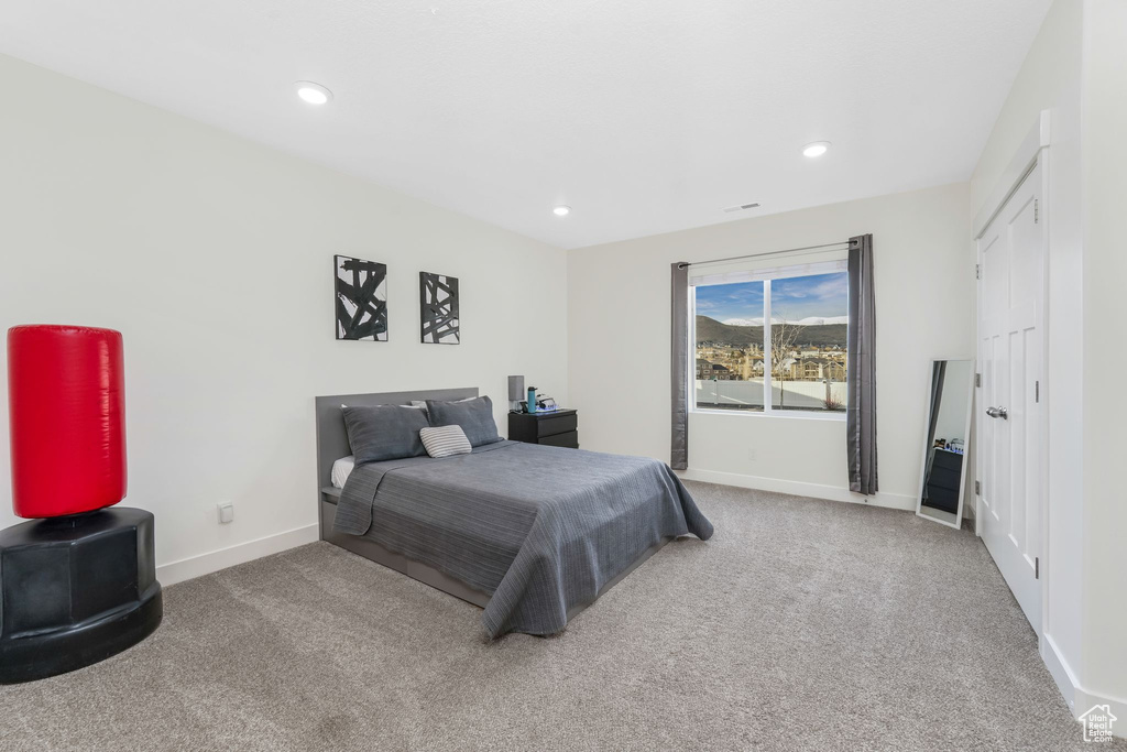 Carpeted bedroom featuring recessed lighting and baseboards