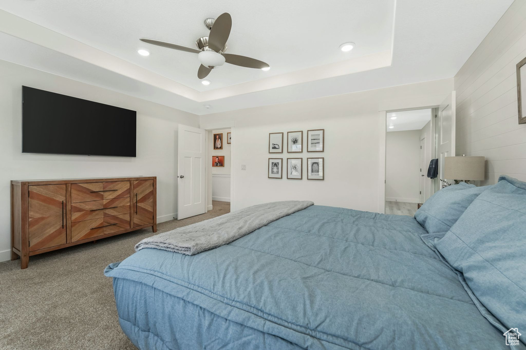 Bedroom featuring recessed lighting, a tray ceiling, ceiling fan, and carpet flooring