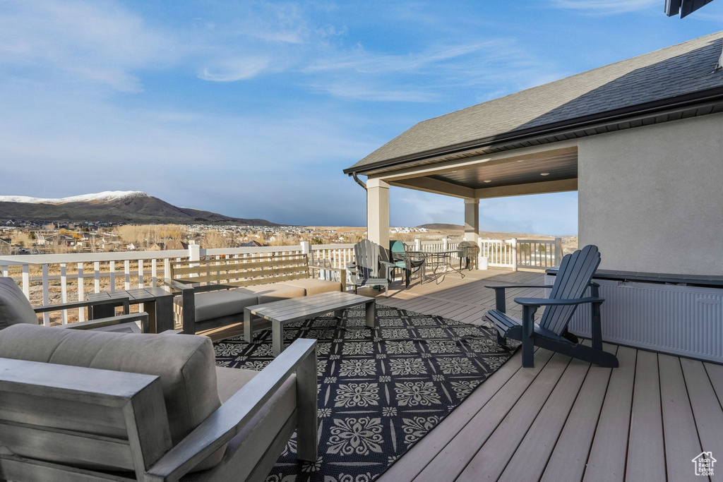 Wooden deck featuring a mountain view and an outdoor hangout area