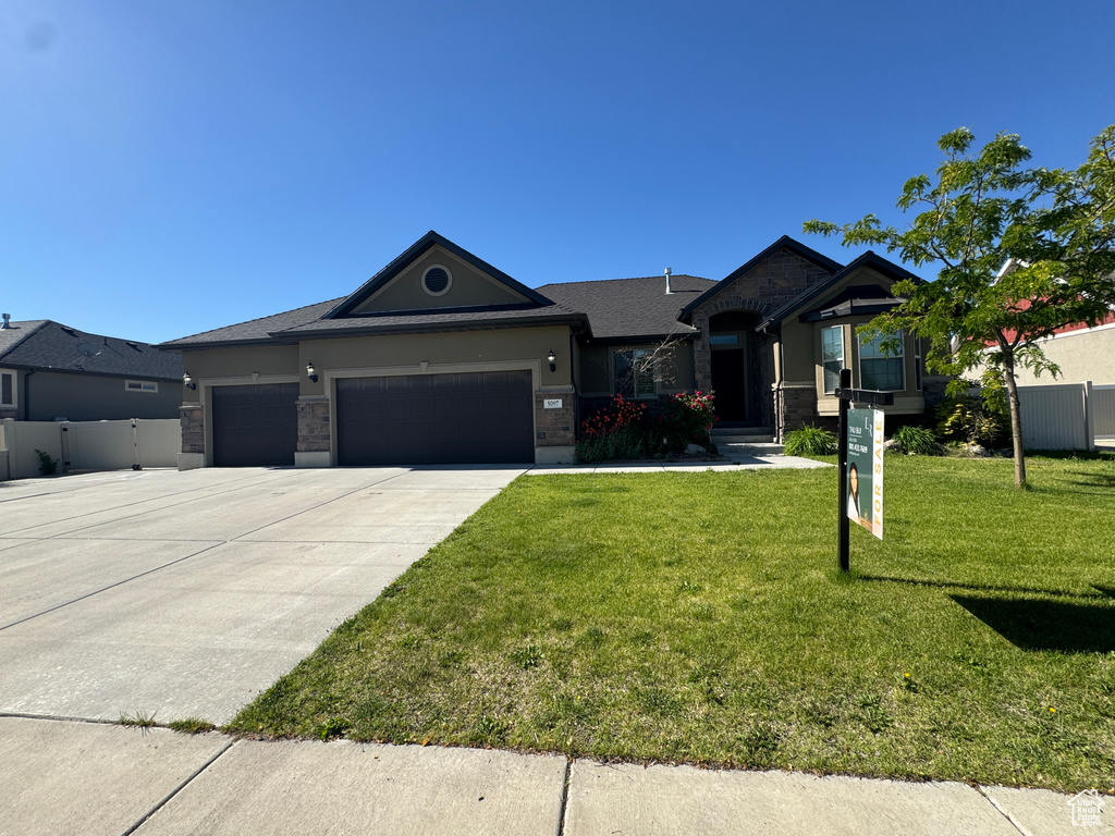 Ranch-style home featuring an attached garage and concrete driveway