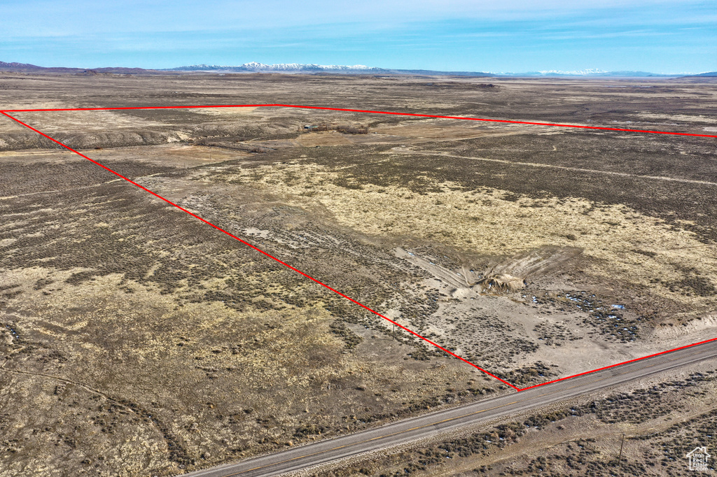 Birds eye view of property featuring a desert view, a mountain view, and a rural view