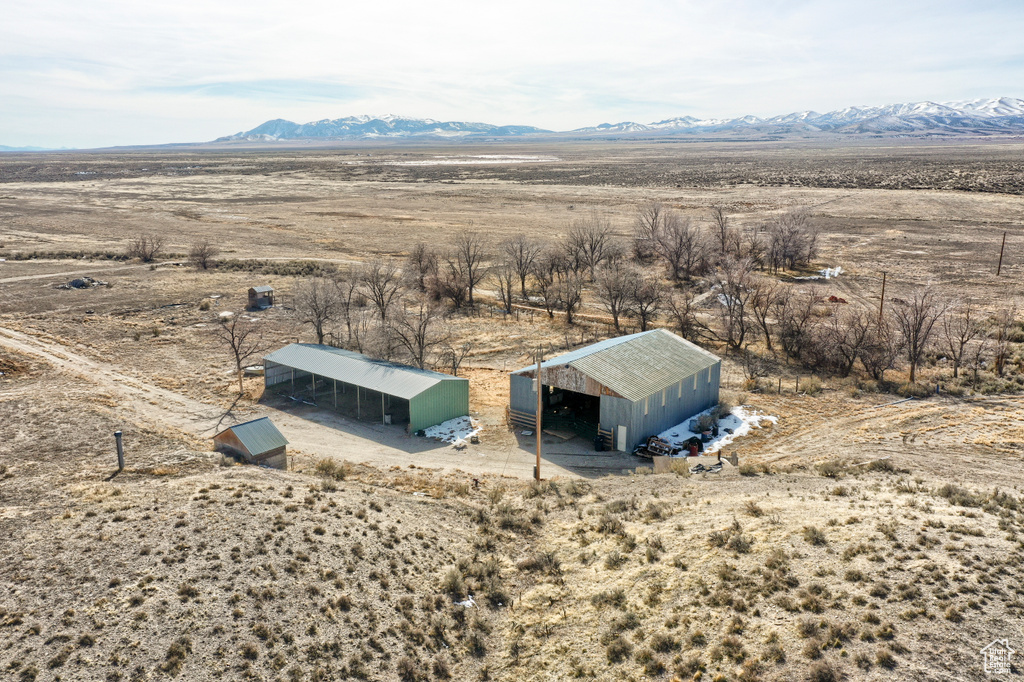 Birds eye view of property featuring a desert view, a rural view, and a mountain view