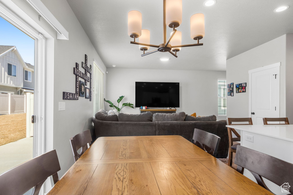 Dining area featuring a notable chandelier and recessed lighting