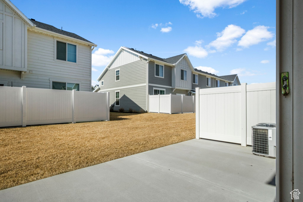 Exterior space featuring a patio, cooling unit, and a fenced backyard