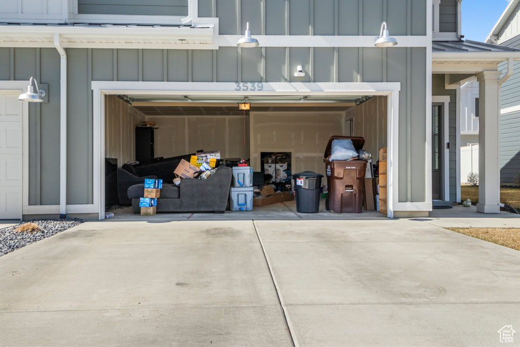 Garage featuring concrete driveway