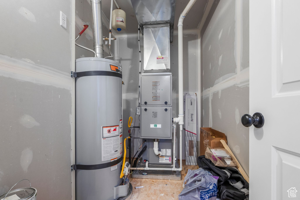 Utility room featuring secured water heater