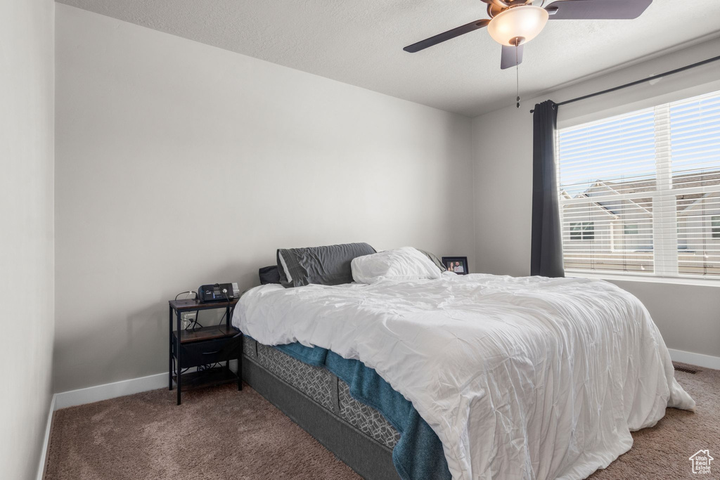 Bedroom featuring carpet, baseboards, and ceiling fan