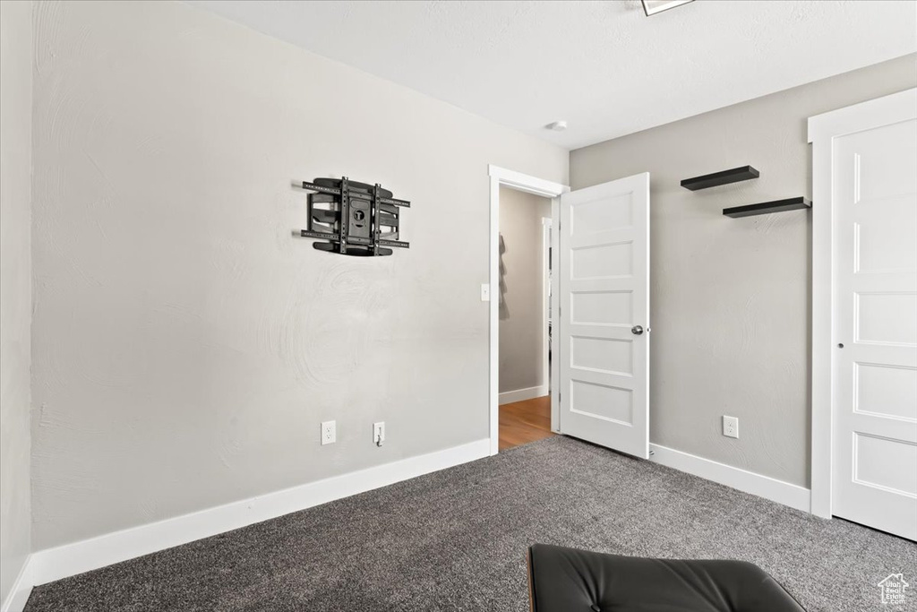 Unfurnished bedroom with baseboards and carpet flooring