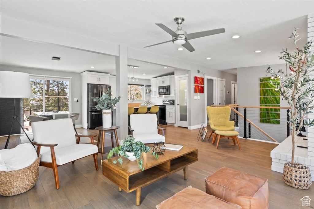 Living room featuring recessed lighting, baseboards, and light wood finished floors