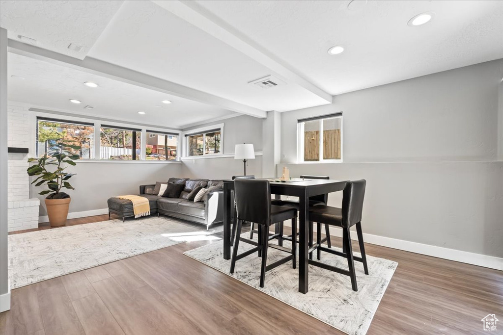 Dining space featuring beam ceiling, recessed lighting, baseboards, and wood finished floors