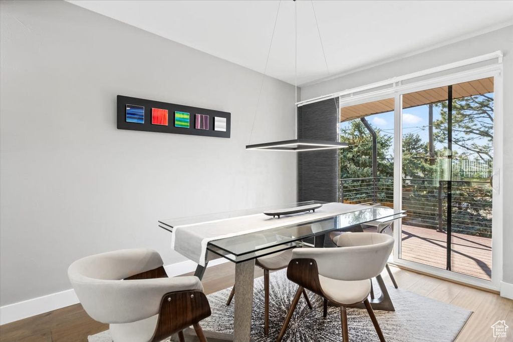 Dining area with baseboards and wood finished floors