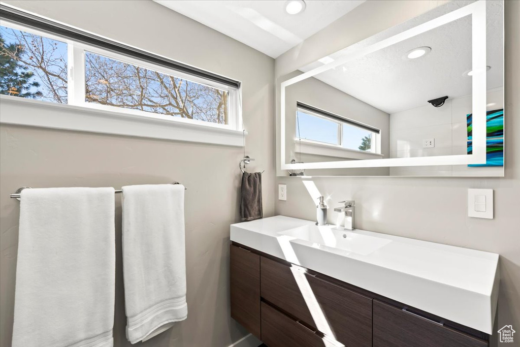 Bathroom with vanity and recessed lighting
