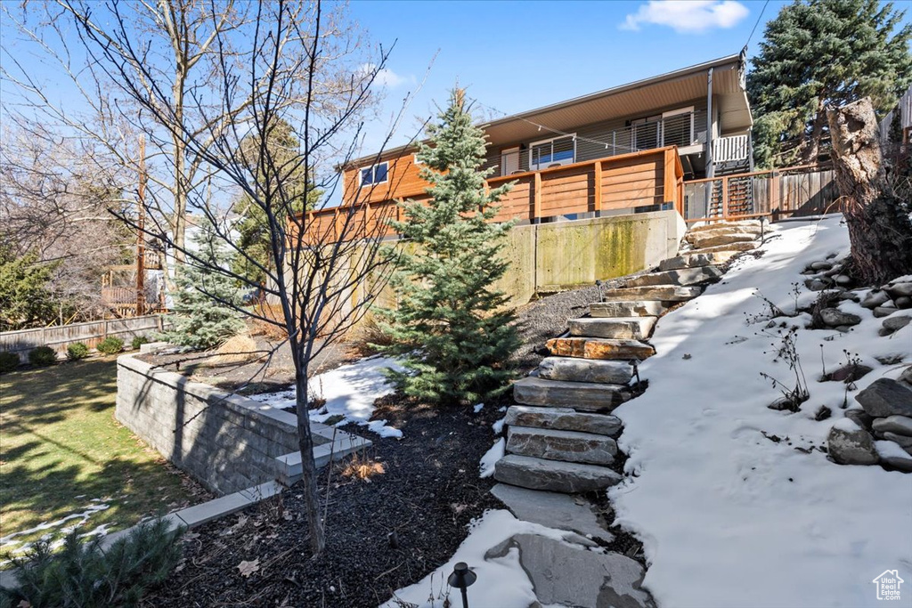View of yard featuring stairway and fence