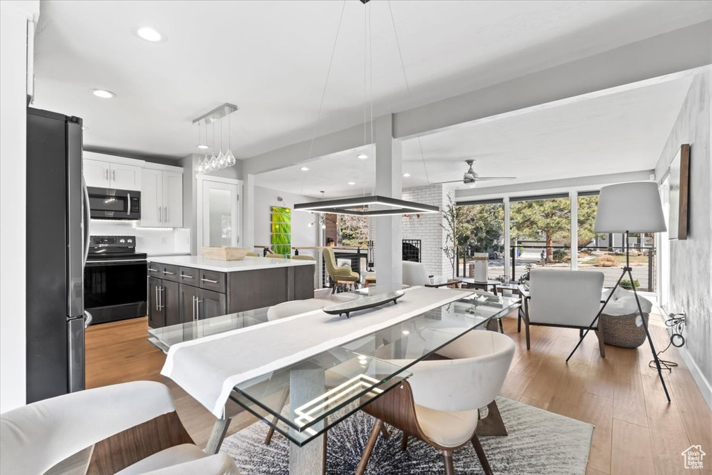 Kitchen featuring light wood-style floors, appliances with stainless steel finishes, a center island, and white cabinetry