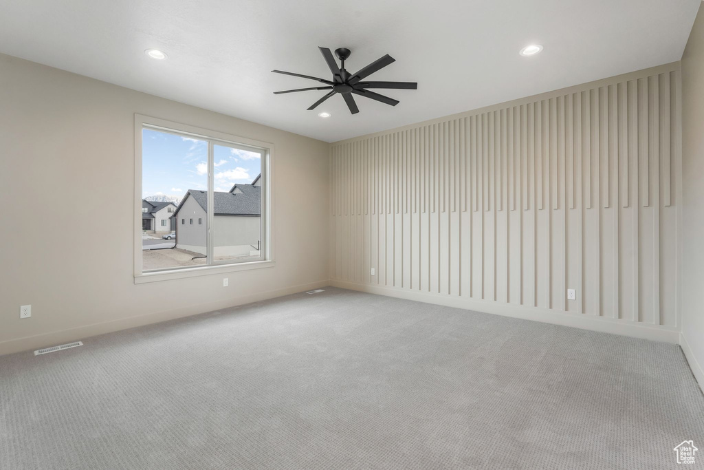 Spare room featuring carpet flooring, recessed lighting, visible vents, and ceiling fan