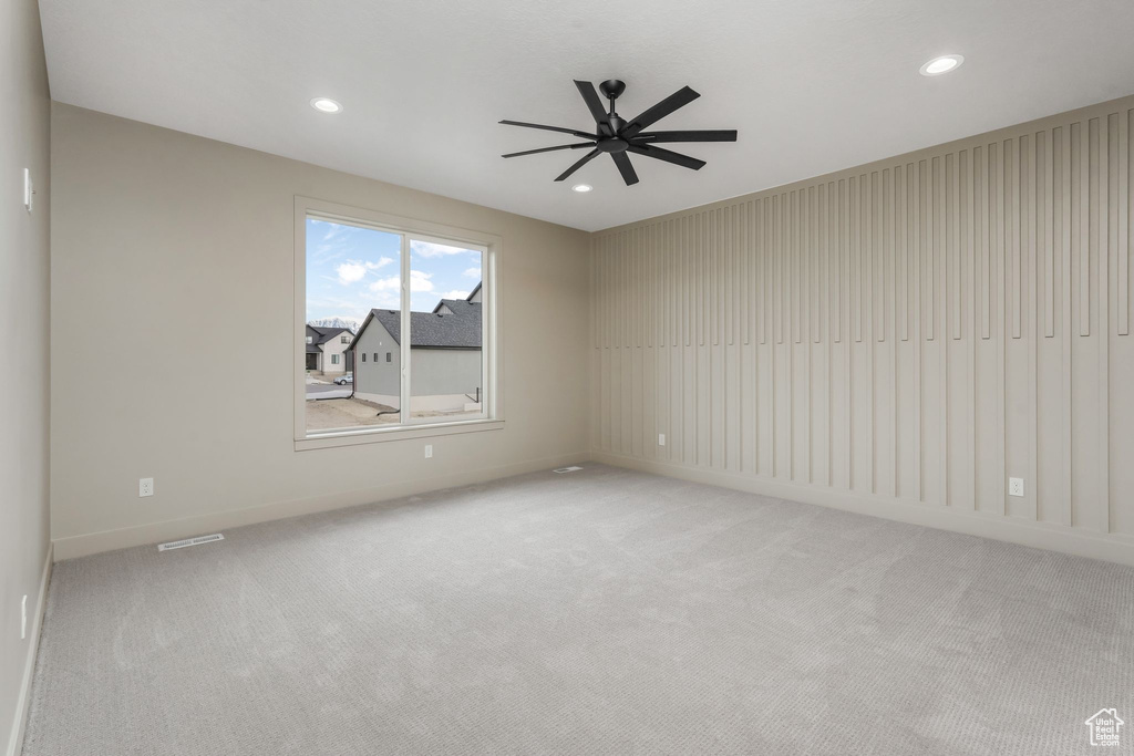 Empty room with light carpet, visible vents, recessed lighting, and a ceiling fan