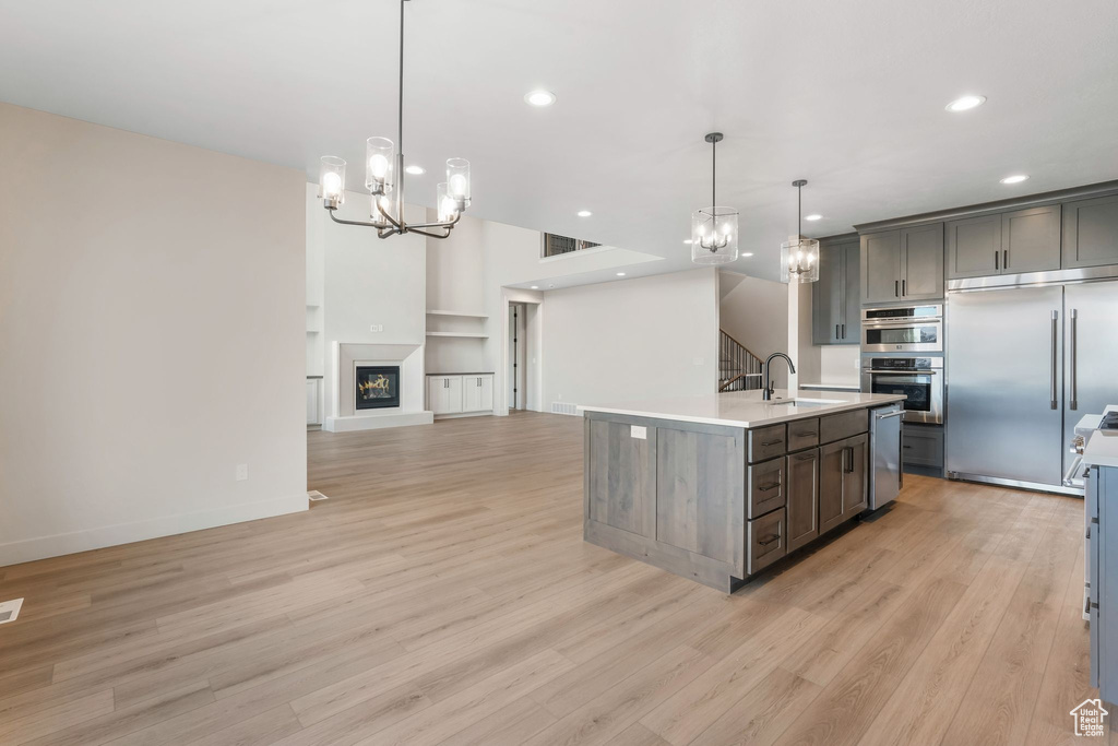 Kitchen with visible vents, open floor plan, light countertops, appliances with stainless steel finishes, and a sink