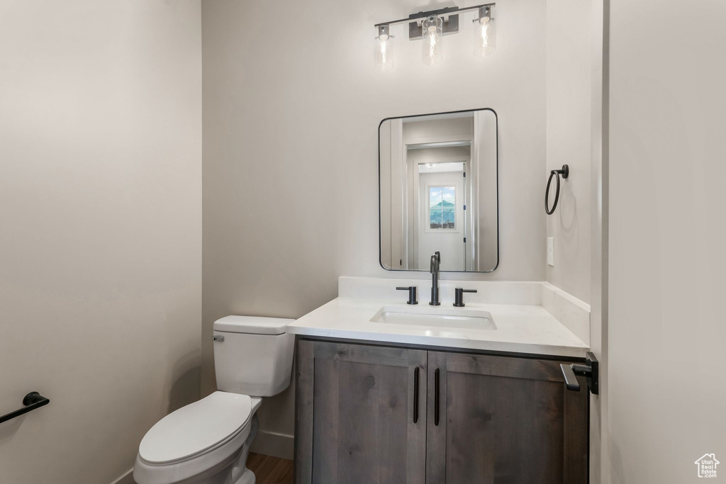Half bathroom with toilet and vanity