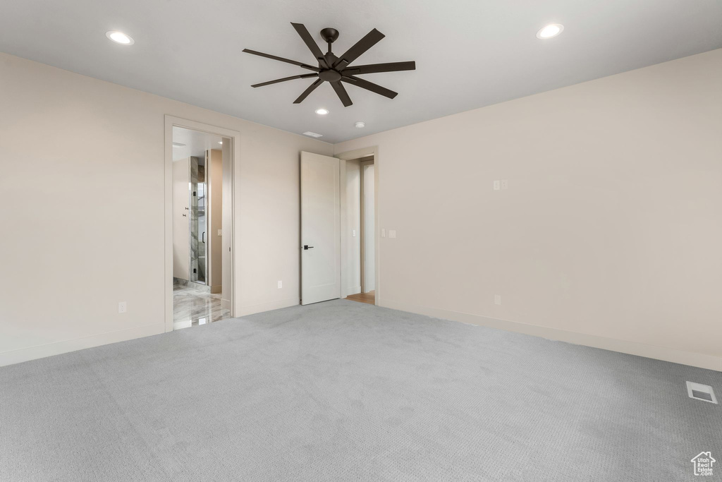 Spare room with a ceiling fan, recessed lighting, and light carpet