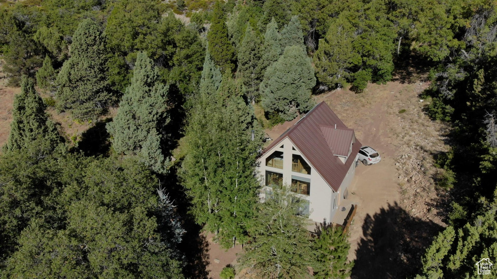 Birds eye view of property with a view of trees