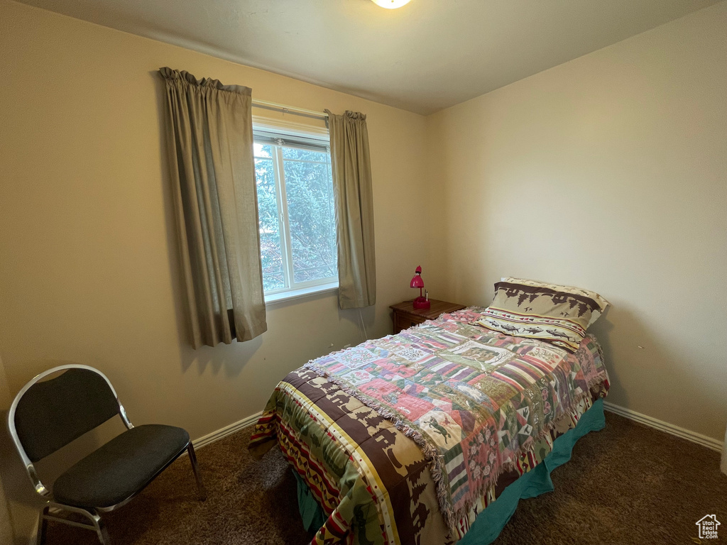 Carpeted bedroom featuring baseboards