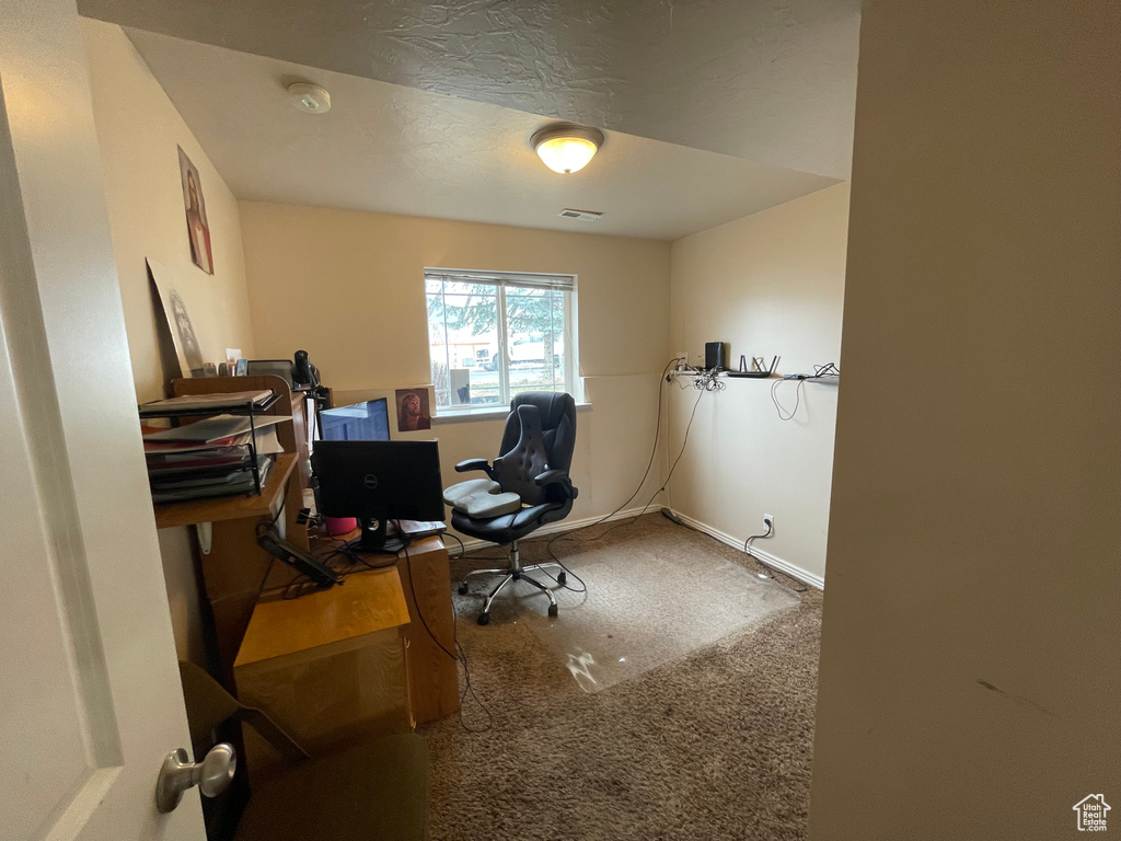Carpeted office space with baseboards and visible vents