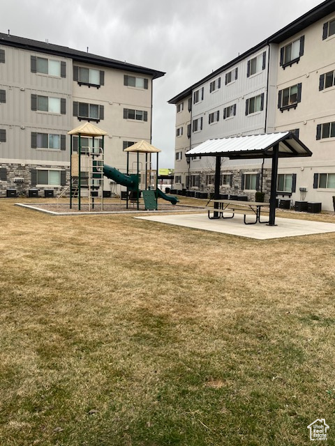 View of property\'s community with a gazebo, playground community, and a lawn