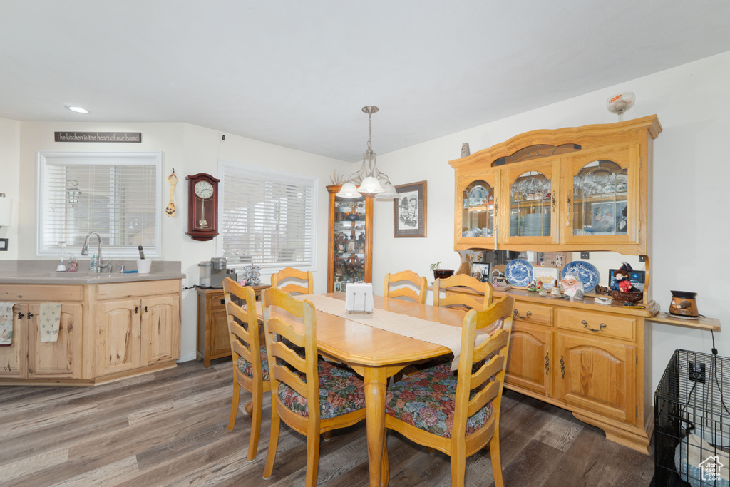 Dining room with light wood-style flooring and recessed lighting