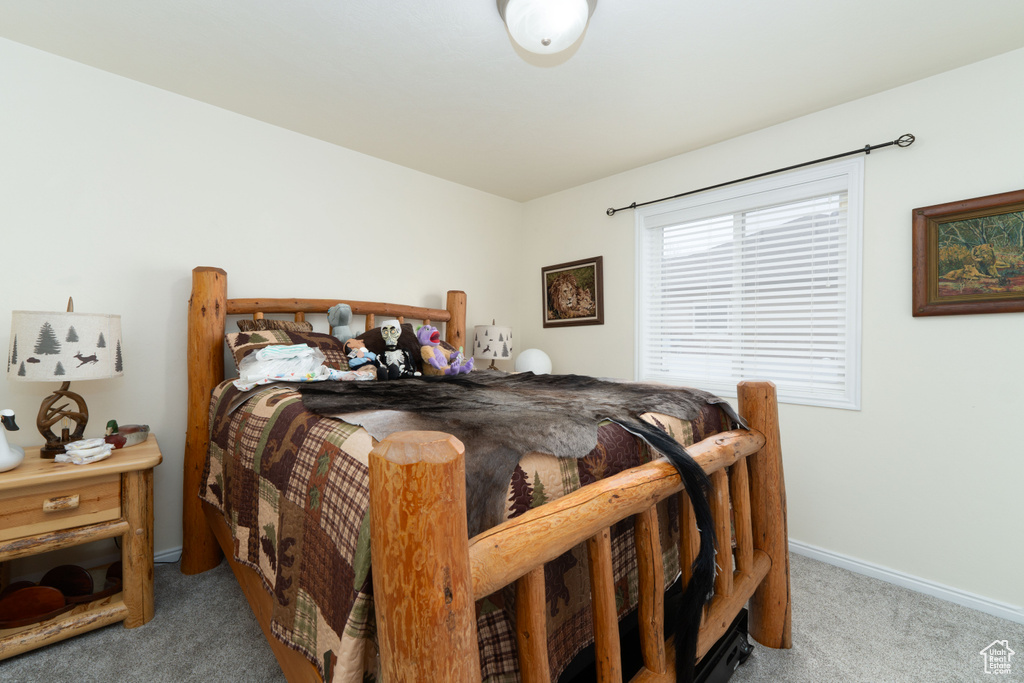 Carpeted bedroom featuring baseboards