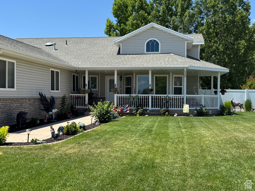 View of front of property featuring roof with shingles and covered porch