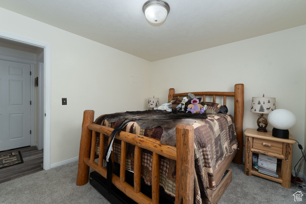 Bedroom with baseboards and carpet floors