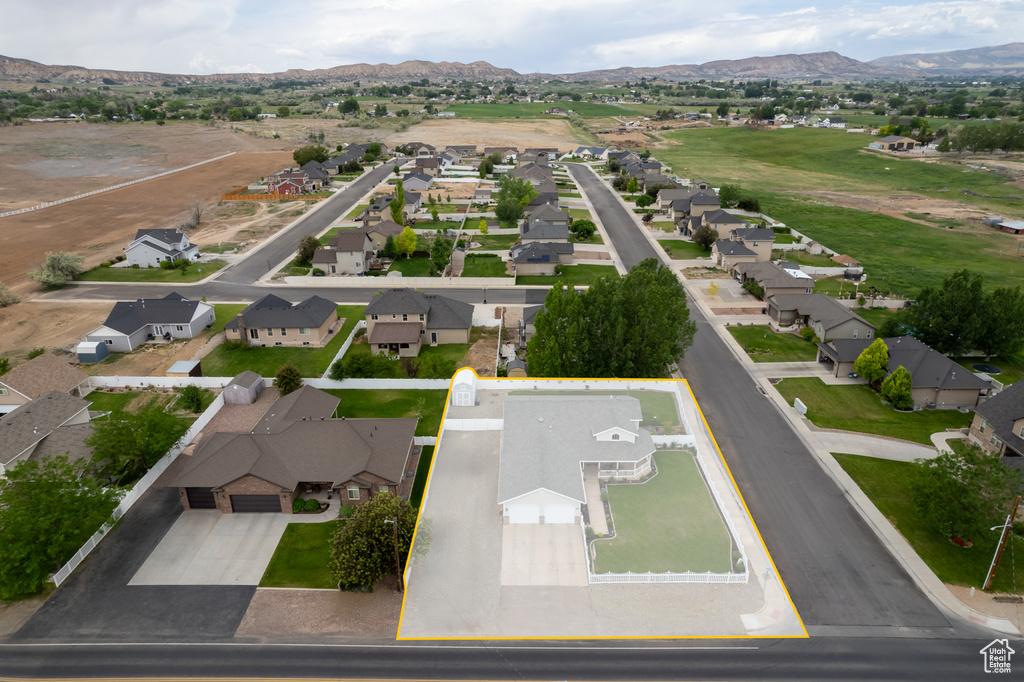 View of property location with nearby suburban area, property parcel outlined, and mountains