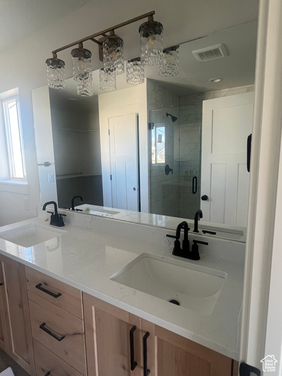 Bathroom with double vanity and a stall shower