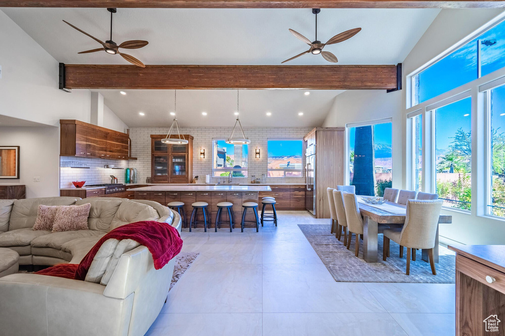 Living area with recessed lighting, beam ceiling, and ceiling fan