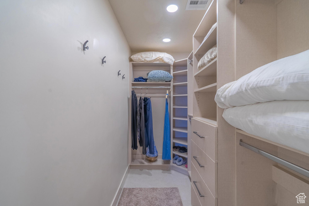 Walk in closet featuring visible vents and carpet floors