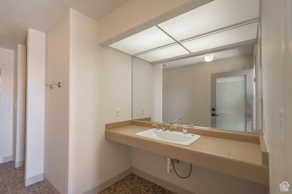 Bathroom with baseboards and a sink
