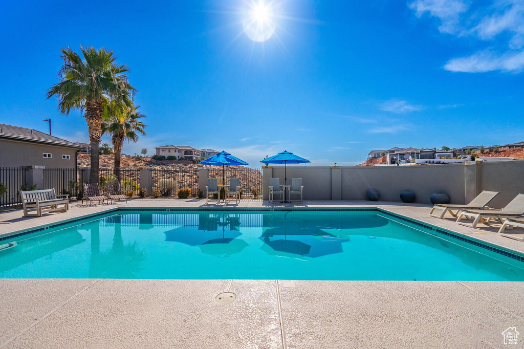 Pool featuring a patio area and fence