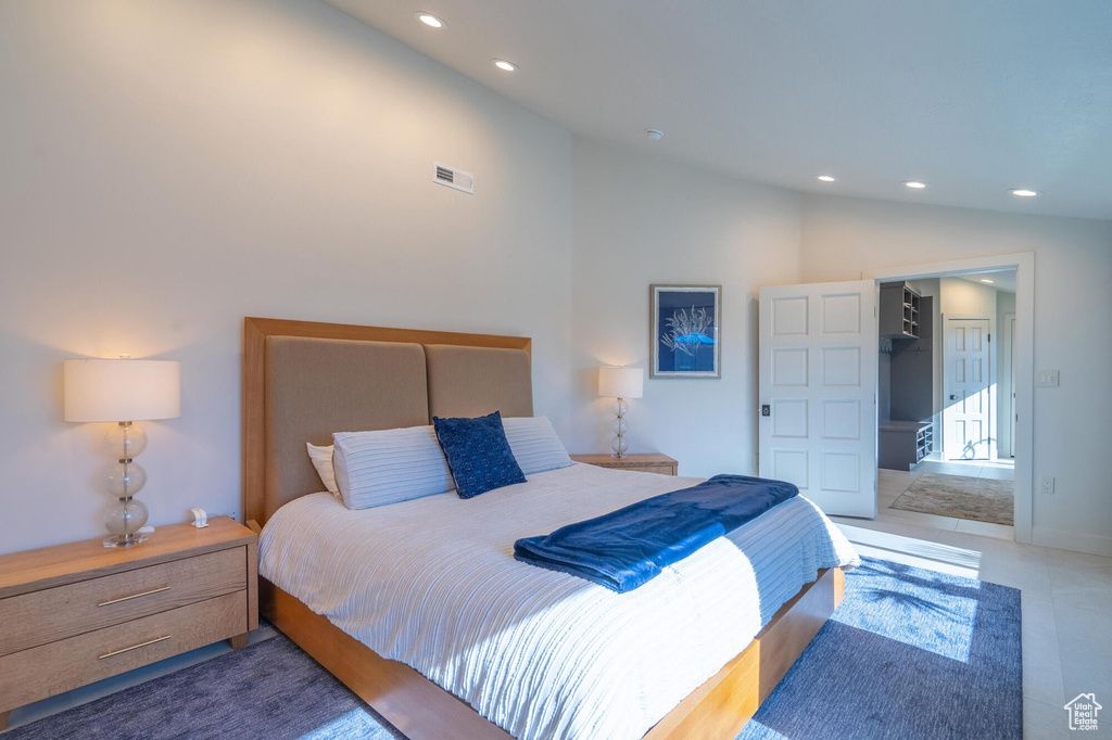 Bedroom with lofted ceiling, a spacious closet, recessed lighting, and visible vents