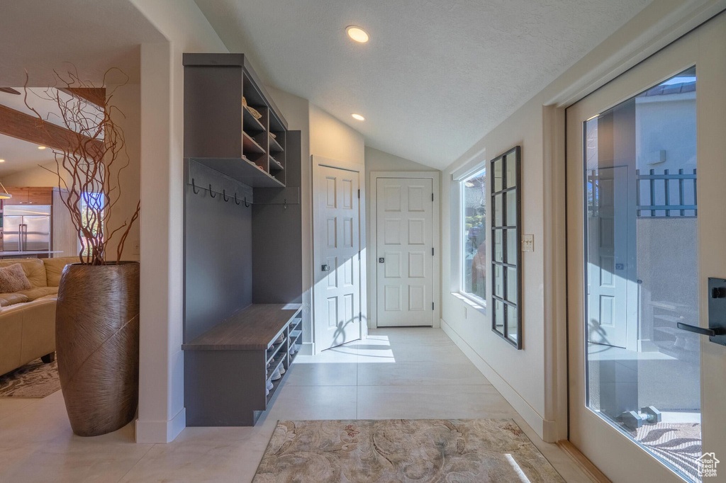 Mudroom featuring lofted ceiling, light tile patterned flooring, recessed lighting, and baseboards