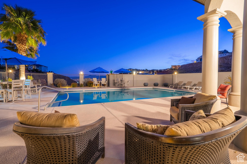 Community pool featuring a patio area and fence