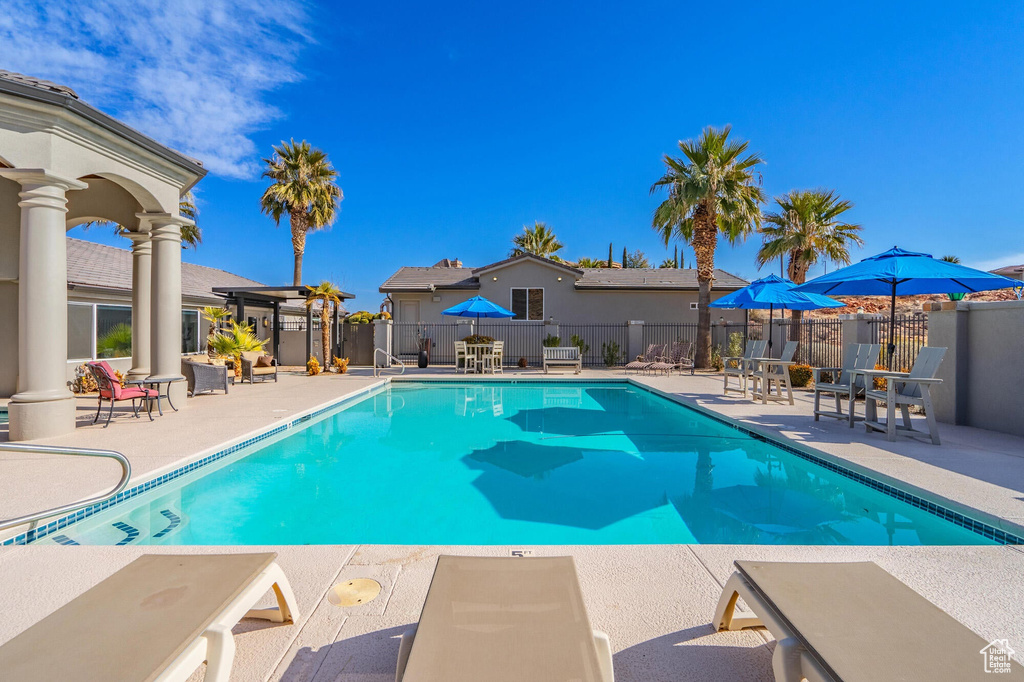 Pool featuring a patio and fence