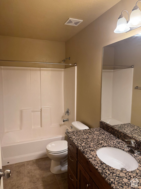 Full bathroom with shower / bathing tub combination, toilet, vanity, visible vents, and tile patterned flooring