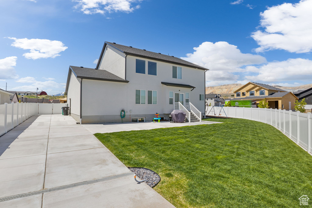 Back of house with stucco siding and a patio area