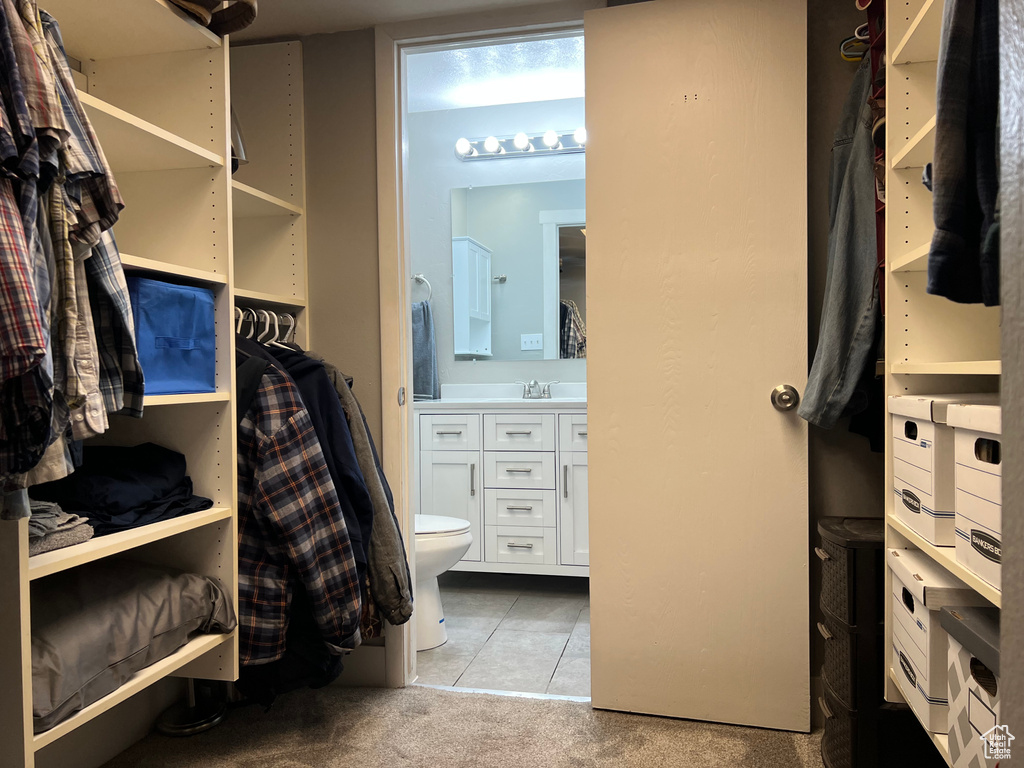 Spacious closet with carpet and tile patterned flooring