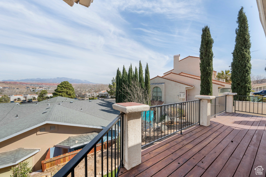 Wooden deck featuring a mountain view and a residential view