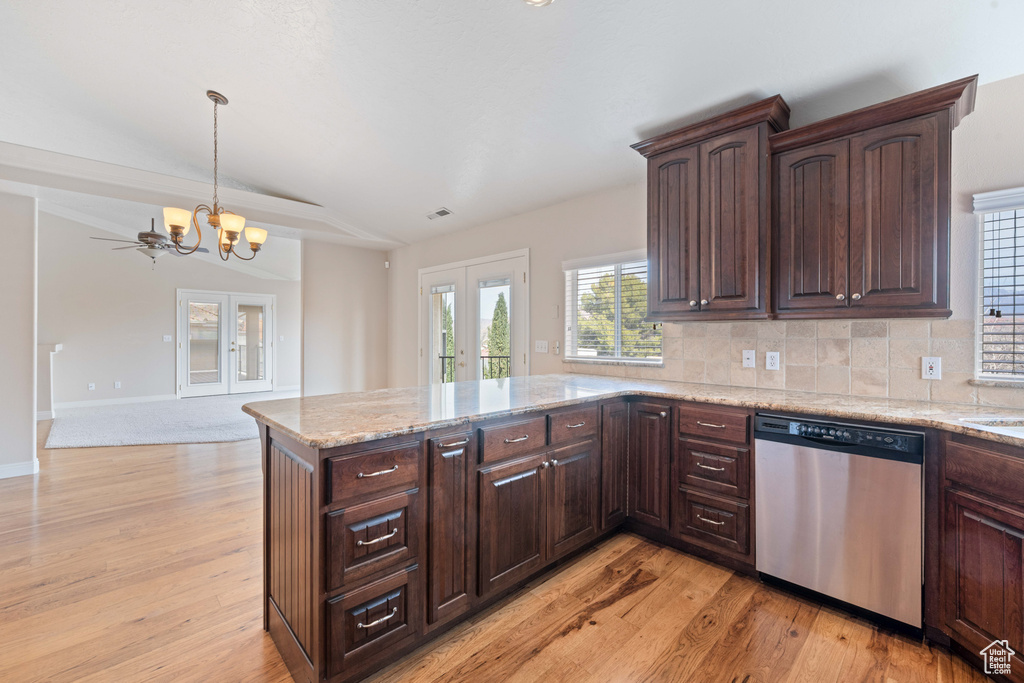 Kitchen featuring french doors, dishwasher, a peninsula, and light wood finished floors