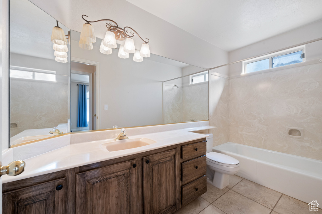 Full bathroom with tile patterned floors, toilet, shower / washtub combination, and vanity