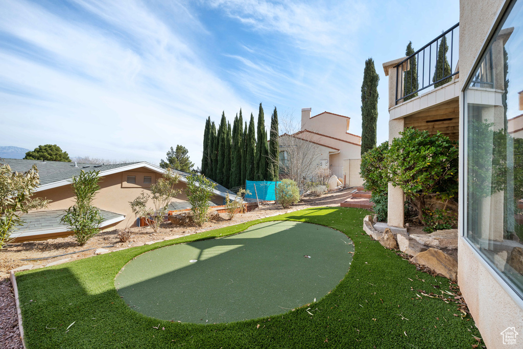 View of yard featuring a balcony